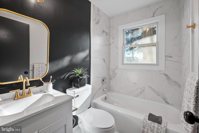 full bathroom with vanity, tiled shower / bath, and toilet