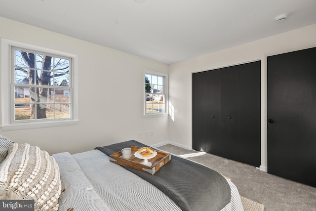 bedroom featuring light carpet