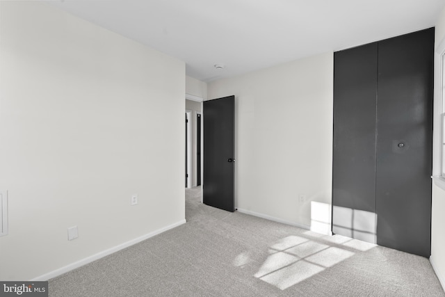 unfurnished bedroom featuring light colored carpet