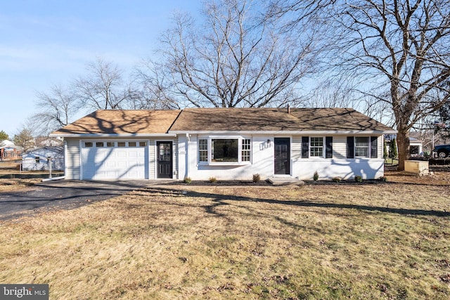 ranch-style house with a garage and a front lawn