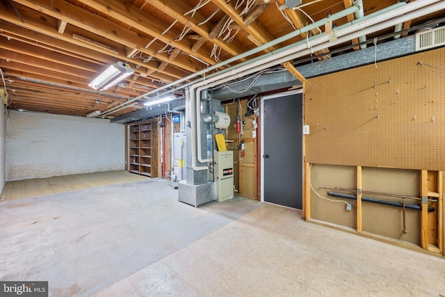 basement featuring water heater and heating unit