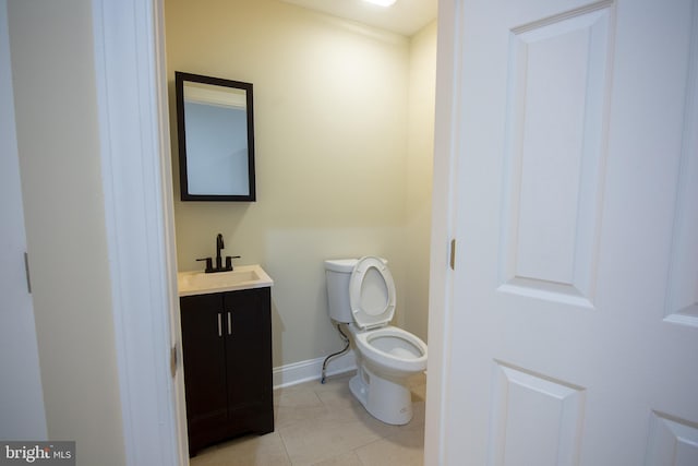 bathroom featuring vanity, toilet, and tile patterned flooring