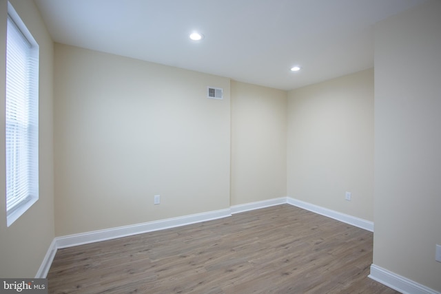 unfurnished room with a healthy amount of sunlight and light wood-type flooring