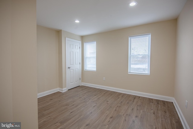 empty room with light hardwood / wood-style flooring