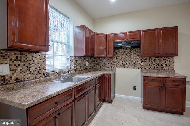 kitchen featuring sink, extractor fan, decorative backsplash, and light tile patterned floors