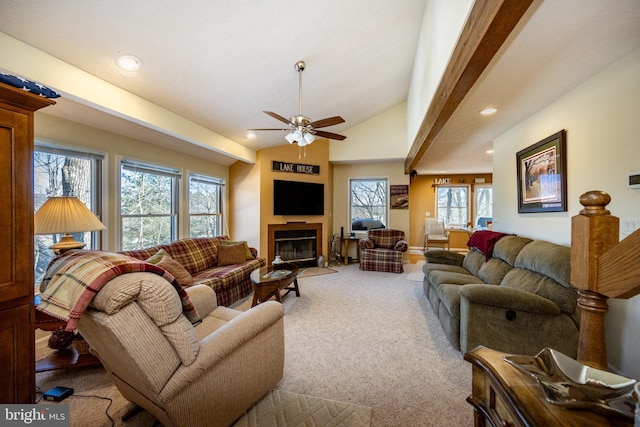 carpeted living room with lofted ceiling and ceiling fan