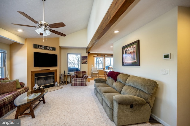 living room with ceiling fan, lofted ceiling, and light colored carpet