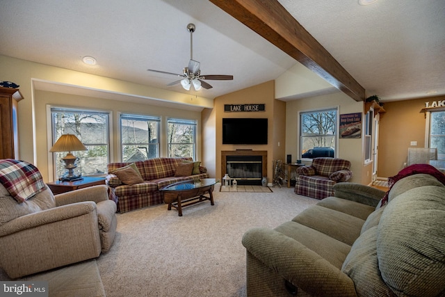 living room featuring ceiling fan, a healthy amount of sunlight, light carpet, and vaulted ceiling with beams