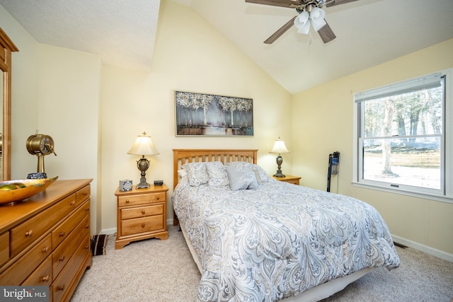 bedroom featuring vaulted ceiling, light carpet, and ceiling fan