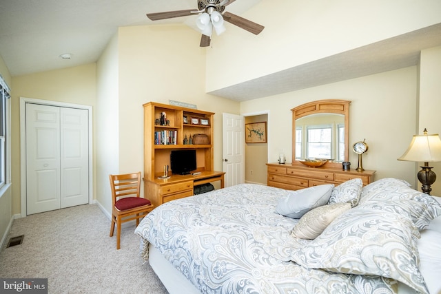 bedroom featuring light carpet, high vaulted ceiling, a closet, and ceiling fan