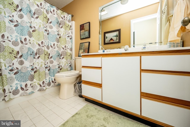 bathroom featuring tile patterned flooring, vanity, and toilet