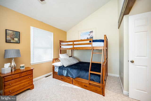 carpeted bedroom featuring vaulted ceiling