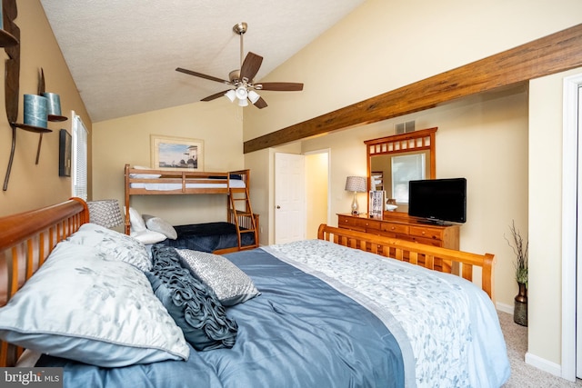 bedroom with ceiling fan, vaulted ceiling, a textured ceiling, and carpet flooring