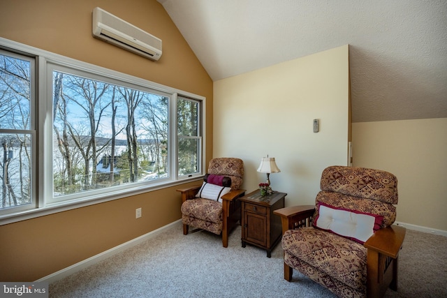 sitting room featuring vaulted ceiling, a wall mounted AC, and light colored carpet