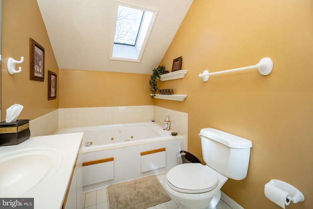 bathroom with vaulted ceiling with skylight, sink, toilet, a bath, and tile patterned floors