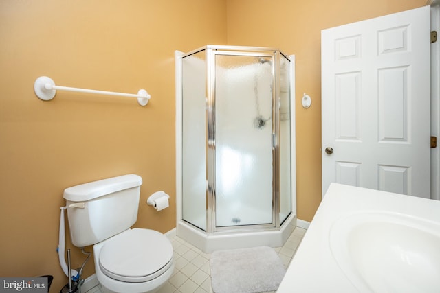 bathroom featuring sink, tile patterned floors, a shower with door, and toilet