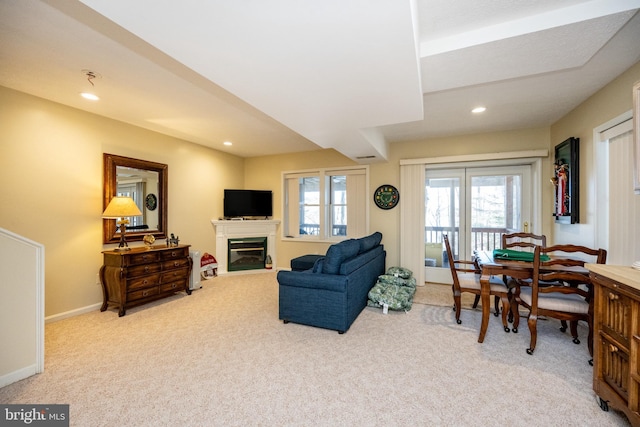 living room with plenty of natural light and light colored carpet