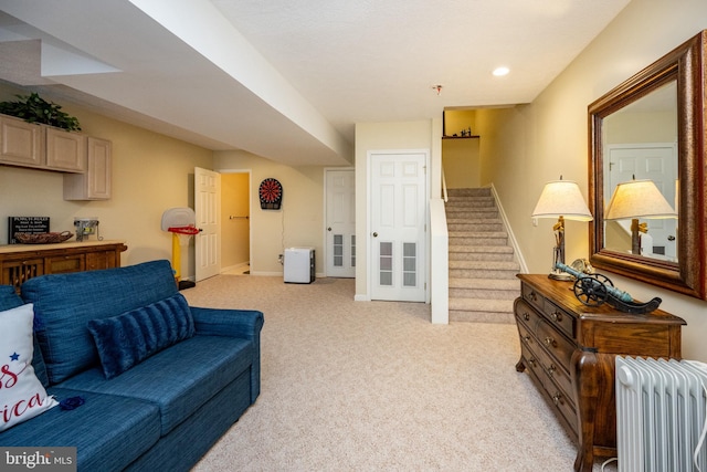 living room featuring light carpet and radiator heating unit