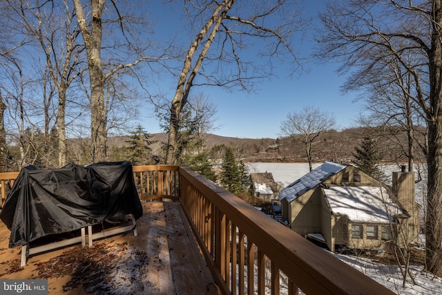 snow covered deck with a mountain view