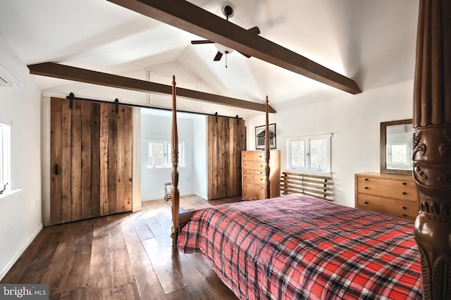 bedroom with lofted ceiling with beams, a barn door, multiple windows, and wood finished floors