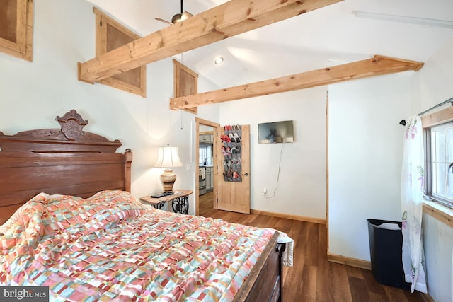 bedroom with lofted ceiling with beams, wood finished floors, and baseboards