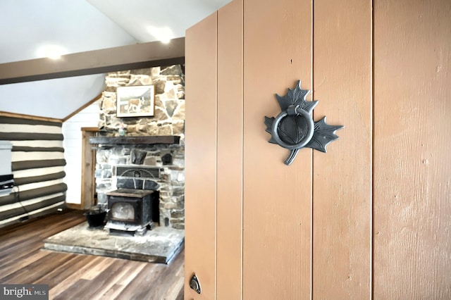 details with a wood stove and wood finished floors