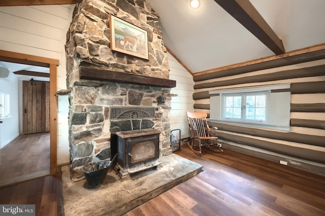 room details featuring wood walls, a wood stove, and wood finished floors