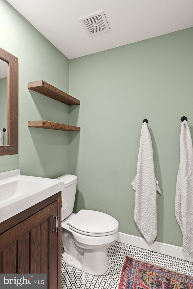 bathroom with vanity, tile patterned floors, and toilet