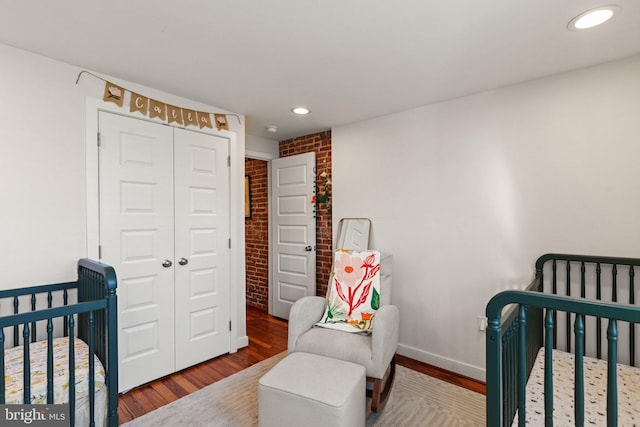 bedroom with hardwood / wood-style flooring and a closet