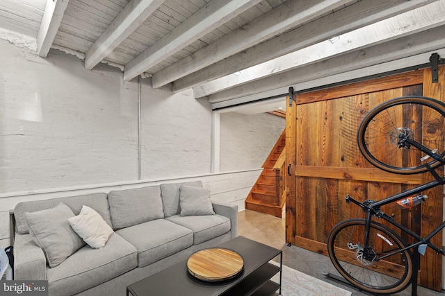 living room with wood ceiling, a barn door, and beamed ceiling