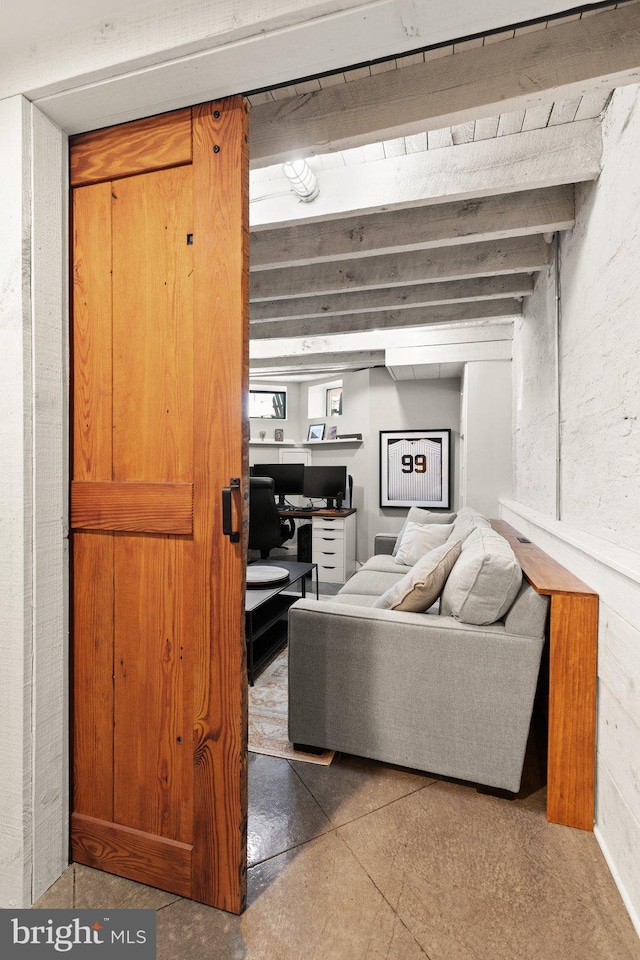 living room with beam ceiling and concrete flooring