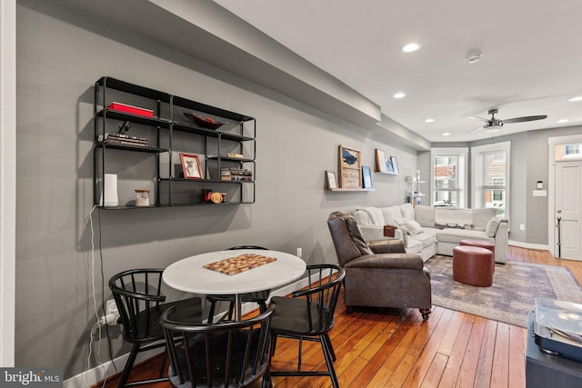 living room with hardwood / wood-style floors and ceiling fan