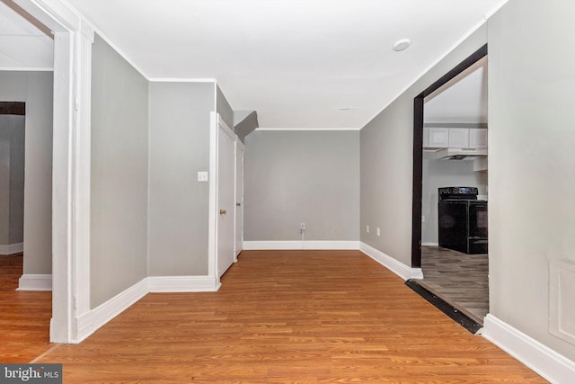 corridor with crown molding and light hardwood / wood-style floors