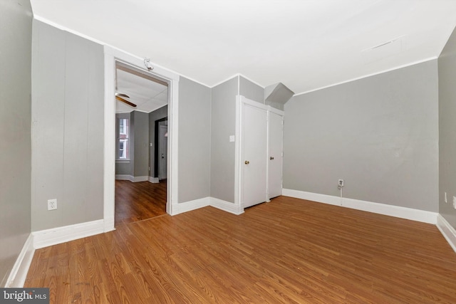 spare room with wood-type flooring and ornamental molding