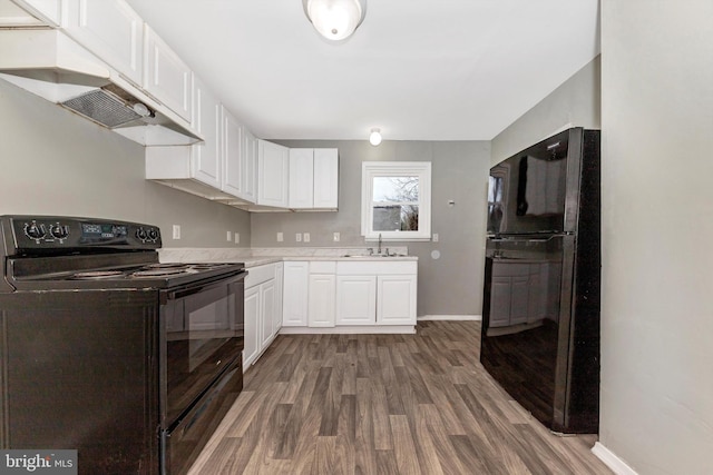 kitchen with white cabinetry, sink, dark hardwood / wood-style flooring, and black appliances