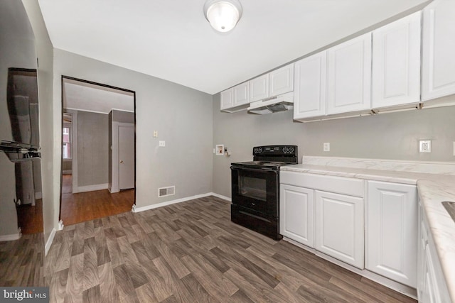 kitchen featuring black / electric stove, white cabinetry, dark wood-type flooring, and light stone counters