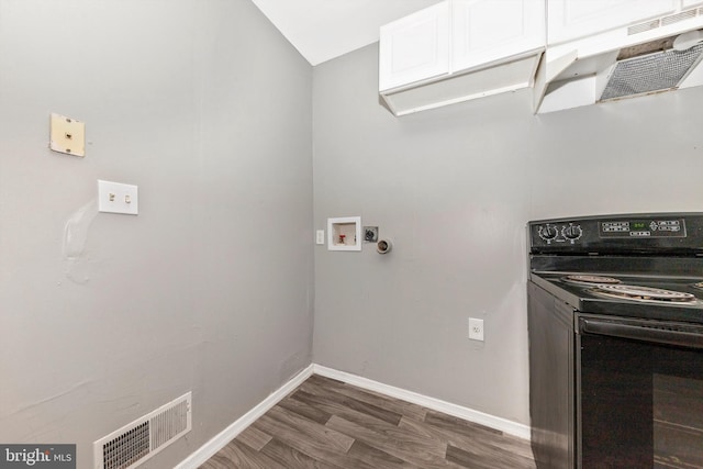 clothes washing area with dark hardwood / wood-style floors and washer hookup