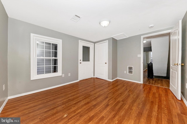 unfurnished bedroom with wood-type flooring and a closet