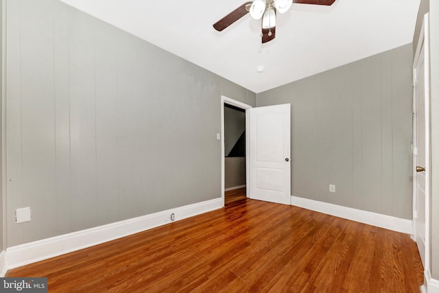 unfurnished bedroom featuring hardwood / wood-style floors and ceiling fan