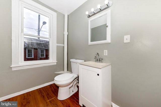 bathroom with vanity, hardwood / wood-style floors, and toilet