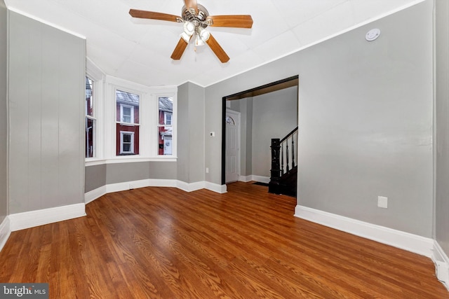 unfurnished room featuring ceiling fan and hardwood / wood-style floors