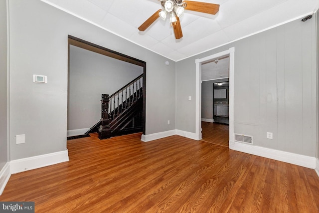 empty room with ceiling fan and wood-type flooring