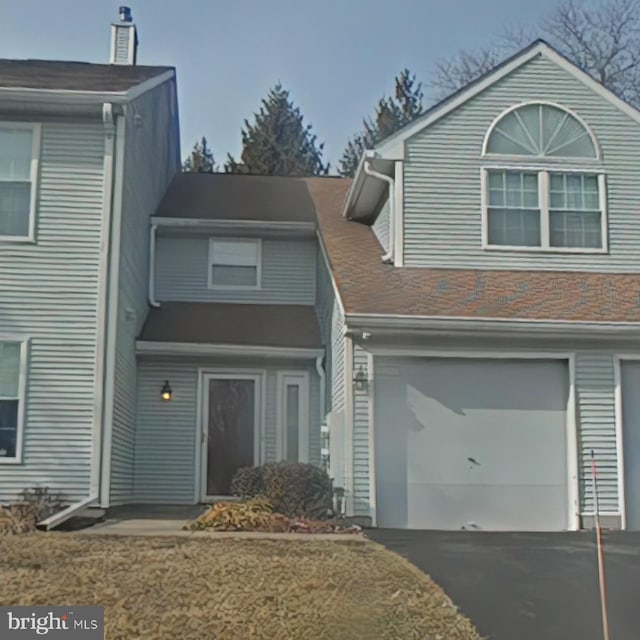 view of front of house with a garage and a front yard