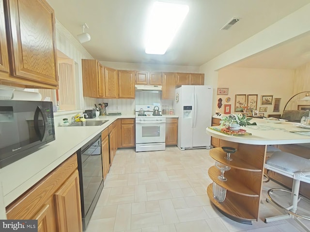 kitchen with sink, backsplash, and black appliances