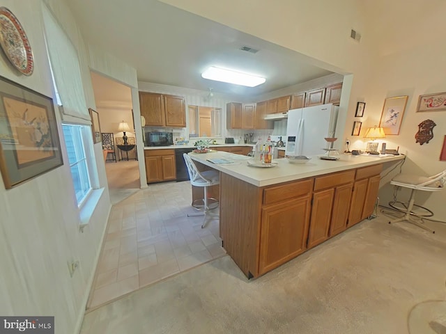 kitchen featuring a center island, a breakfast bar area, and black appliances