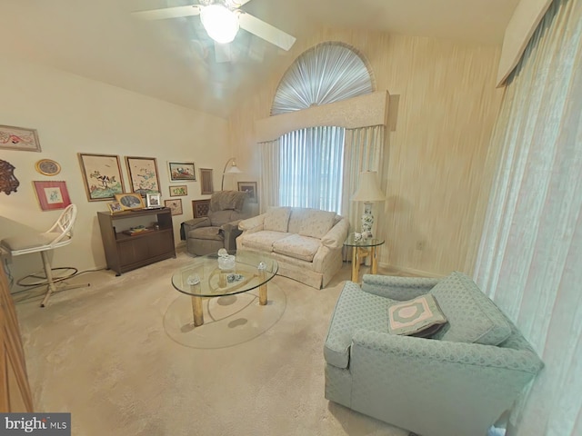 living room featuring ceiling fan, lofted ceiling, and carpet