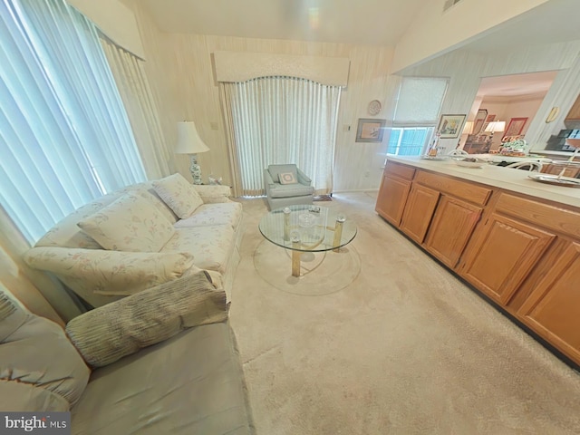 carpeted living room with vaulted ceiling