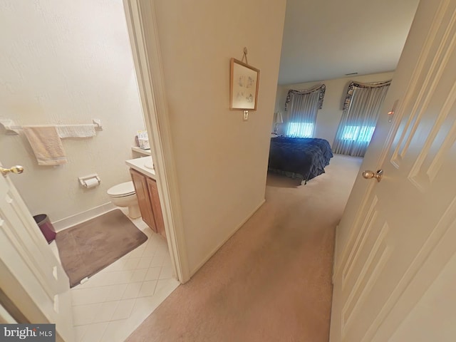 bathroom featuring vanity, tile patterned flooring, and toilet