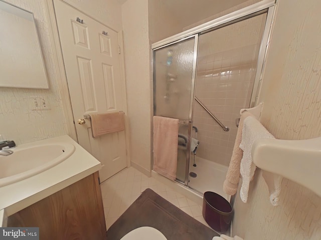 bathroom featuring vanity, tile patterned floors, and a shower with shower door