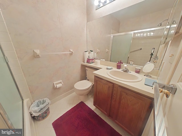 bathroom with vanity, toilet, a shower with shower door, and tile patterned flooring